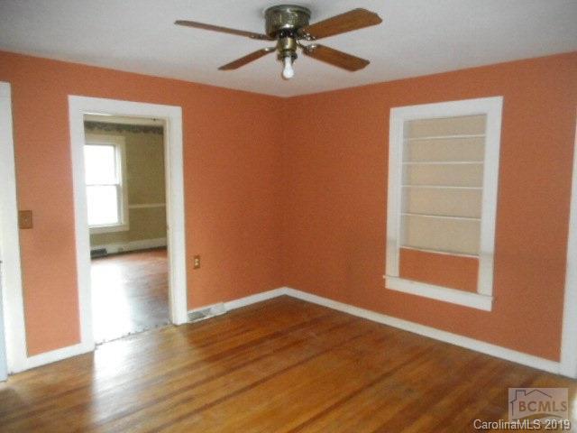 453 Poors Ford Road Rutherfordton, NC 28139 - Photo 3 of 15 wooden floor in an empty room with a window