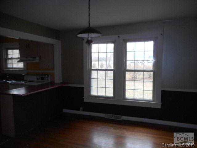 453 Poors Ford Road Rutherfordton, NC 28139 - Photo 4 of 15 a view of an empty room with wooden floor and a window