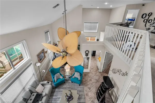 a living room with furniture and a floor to ceiling window