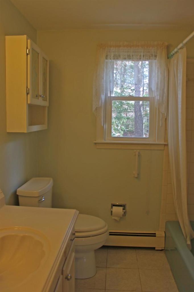 250 Cap'n Lijah's Road Centerville, MA 02632 - Photo 17 of 35 a bathroom with a sink and a toilet