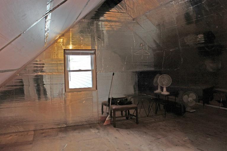 250 Cap'n Lijah's Road Centerville, MA 02632 - Photo 22 of 35 a view of a room with exposed radiator and a window