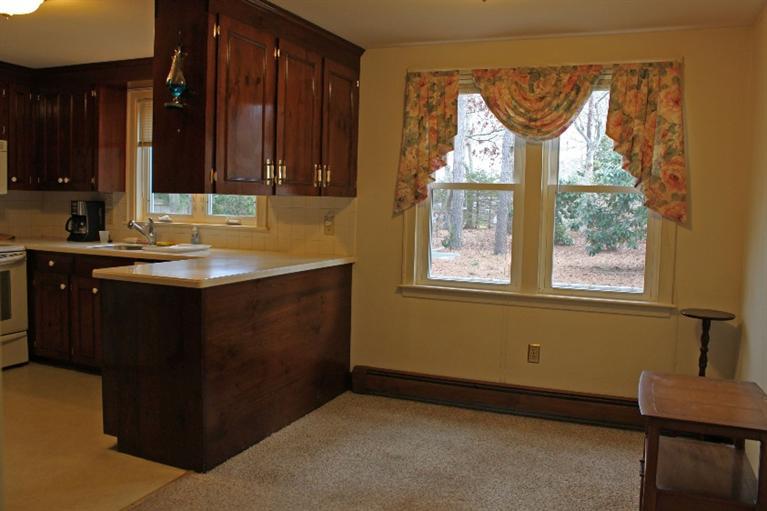 250 Cap'n Lijah's Road Centerville, MA 02632 - Photo 5 of 35 a kitchen with a sink cabinets and window