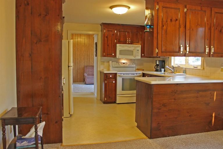 250 Cap'n Lijah's Road Centerville, MA 02632 - Photo 6 of 35 a kitchen with stainless steel appliances granite countertop a sink stove and refrigerator