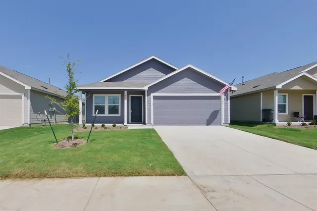 a front view of a house with a garden and porch