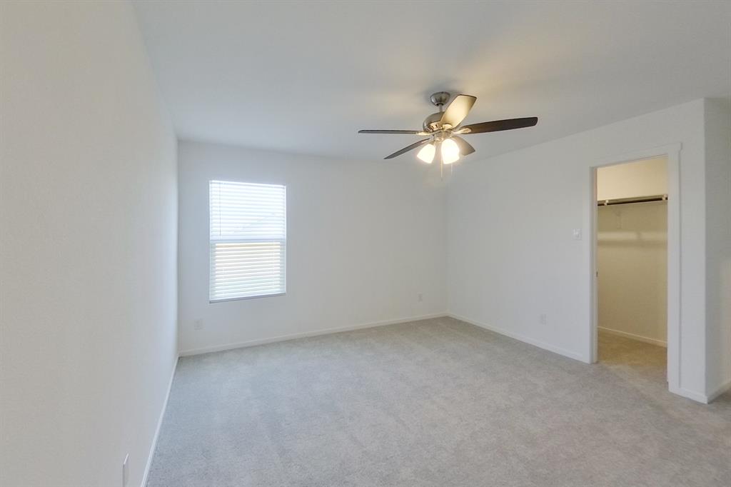 807 Ginkgo Way Princeton, TX 75407 - Photo 12 of 22 a view of an empty room with a ceiling fan and a window