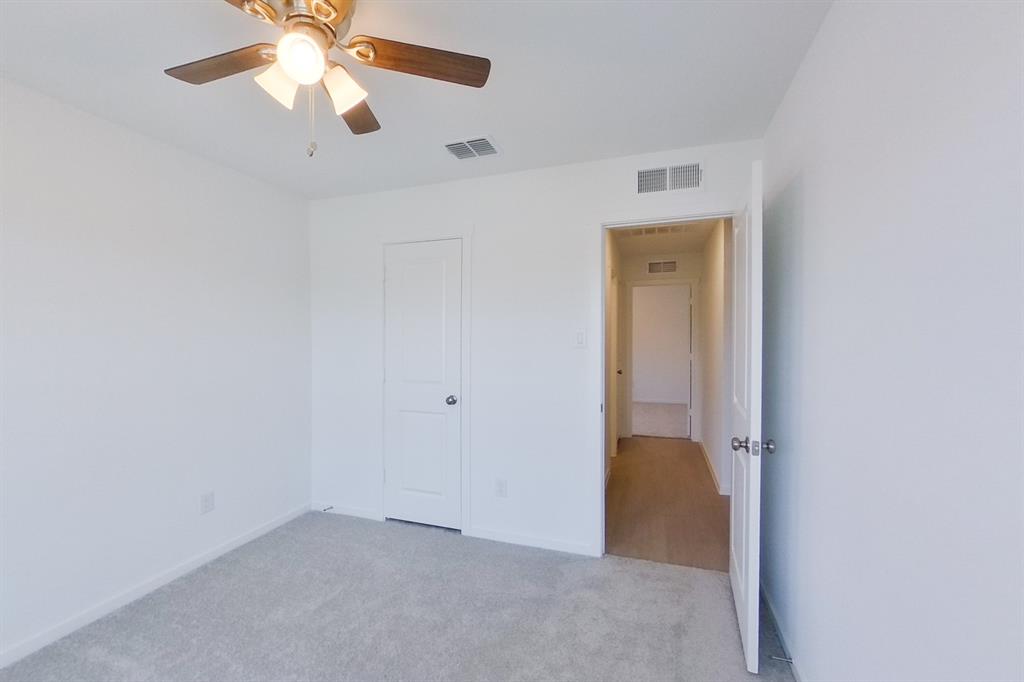 807 Ginkgo Way Princeton, TX 75407 - Photo 3 of 22 an empty room with a ceiling fan and a fan