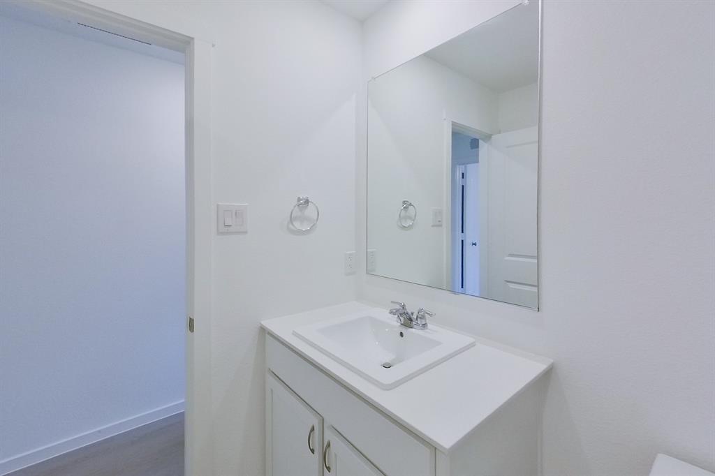 807 Ginkgo Way Princeton, TX 75407 - Photo 4 of 22 a bathroom with a sink a mirror and vanity