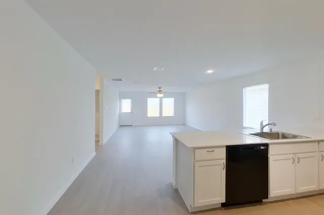 a kitchen with a sink cabinets and a window