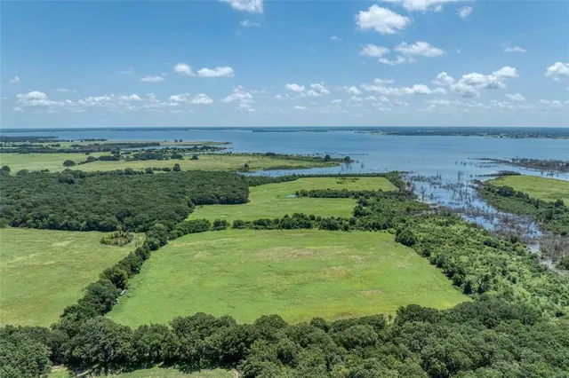 a view of a big yard with lots of green space