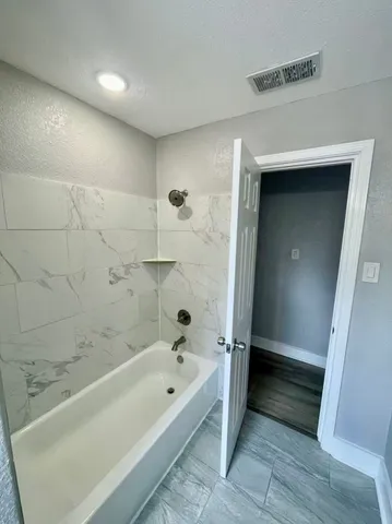 a bathroom with a bathtub and a shower