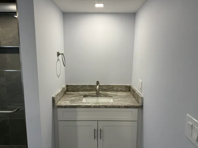 a white toilet sitting in a bathroom next to a window