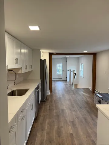 a kitchen with a sink and refrigerator