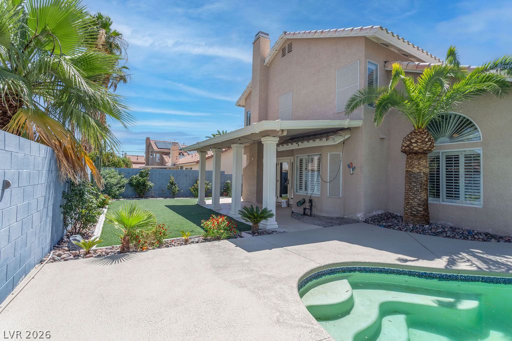 1416 Walstone Road North Las Vegas, NV 89031 - Photo 47 of 47 Lush landscaping surrounds this private yard with a refreshing in-ground pool and shaded patio.