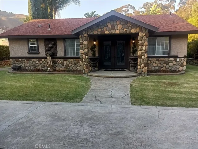 a front view of a house with a garden