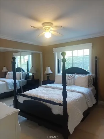 a bedroom with a bed and view of living room