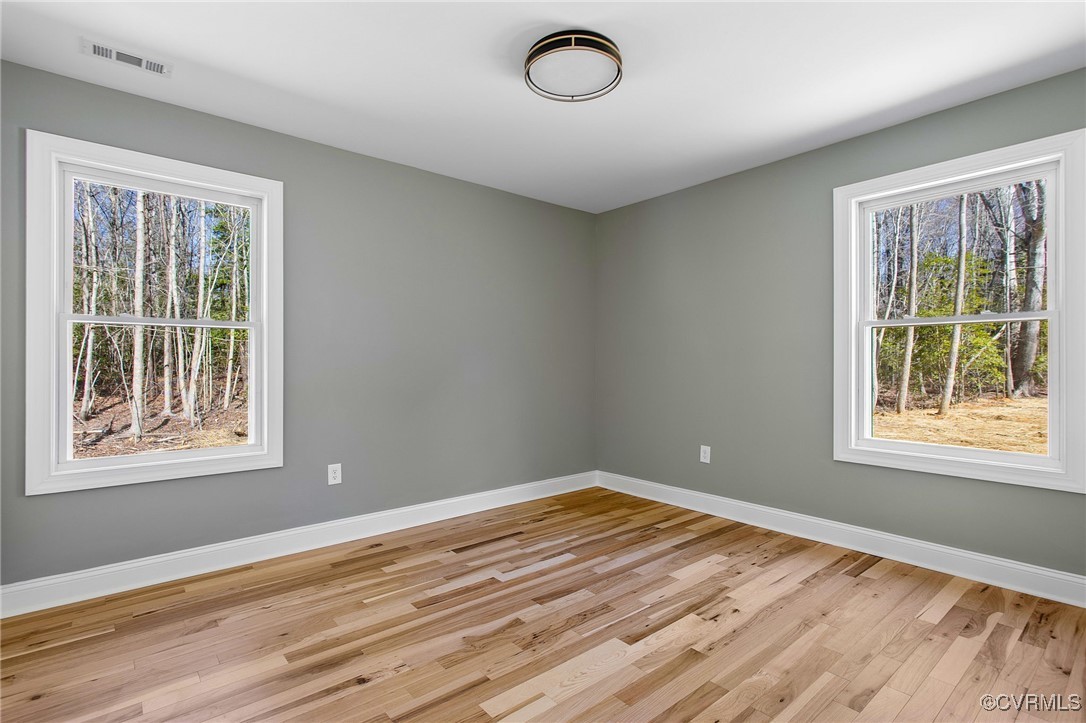 8001 Courthouse Road Providence Forge, VA 23140 - Photo 21 of 28 a view of empty room with wooden floor and fan