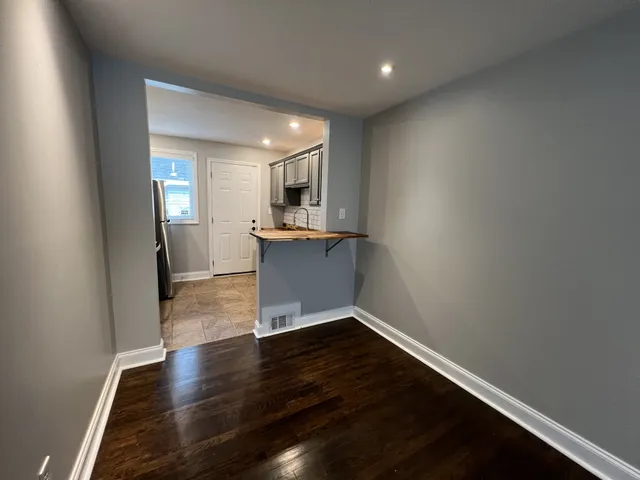 a view of a kitchen with wooden floor and a sink
