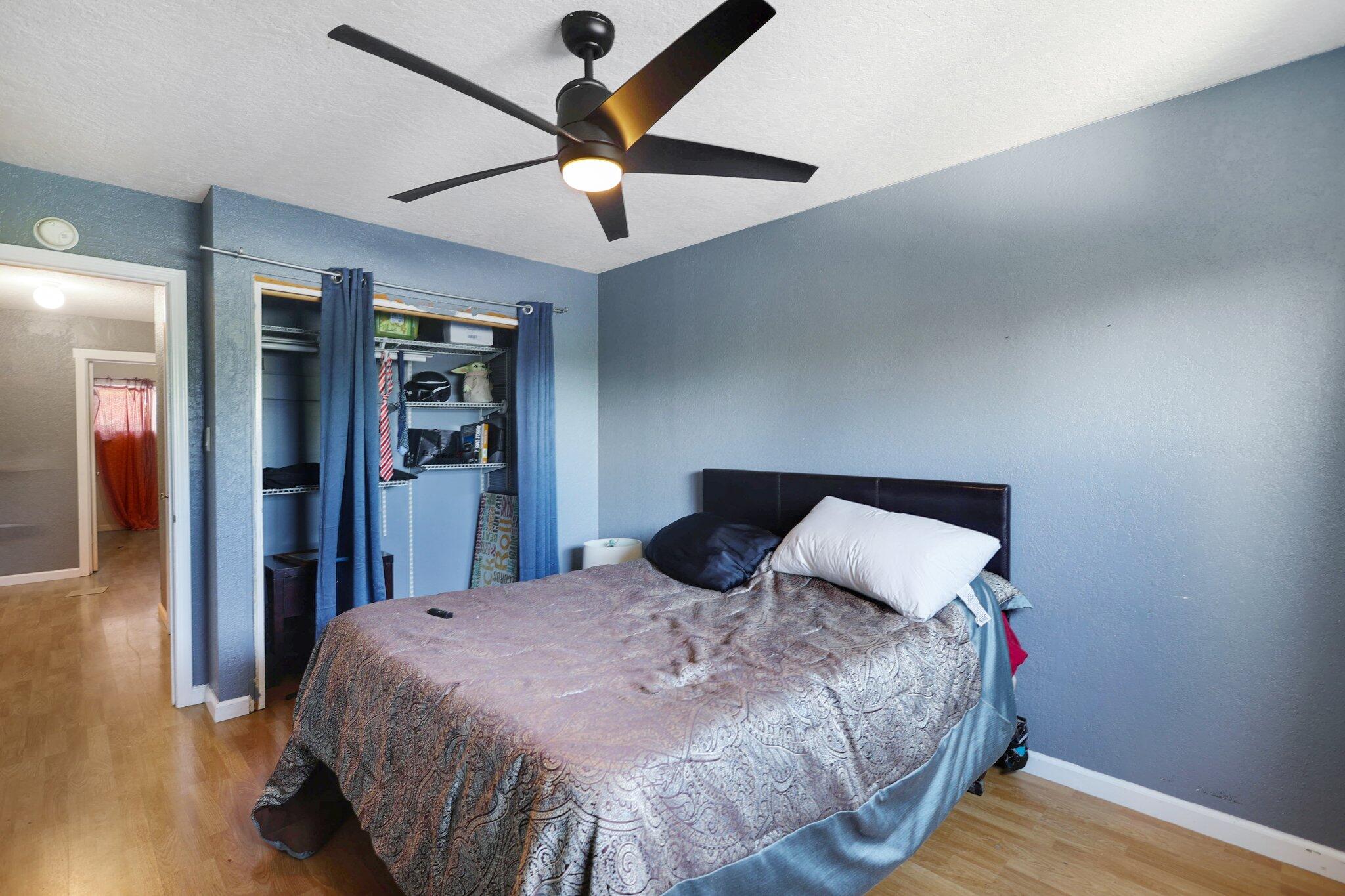 665 Overhill Drive Redding, CA 96001 - Photo 19 of 35 a bedroom with a large bed and a chandelier