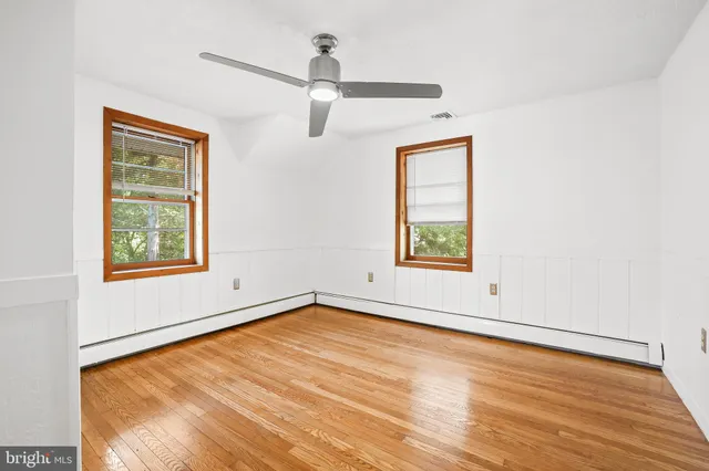 a view of a room with wooden floor and large window