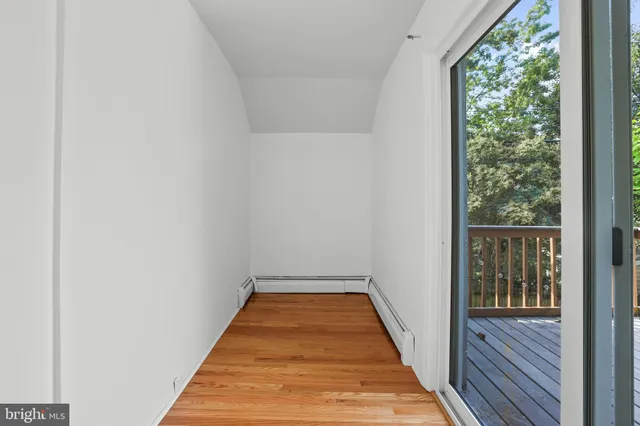 a balcony with wooden floor and fence