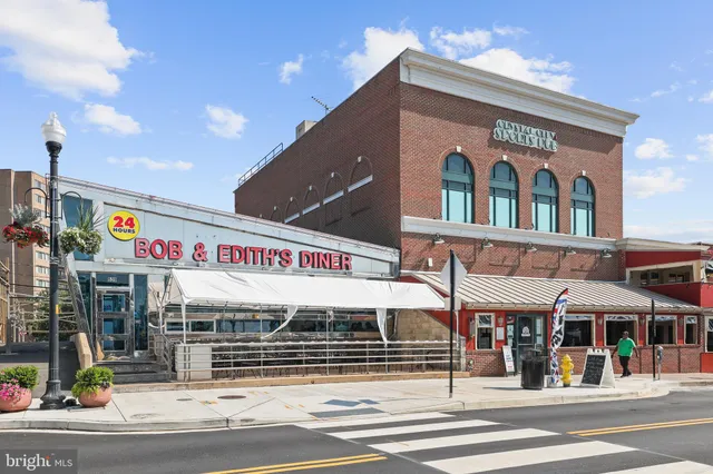 a sign board with parking yard in back