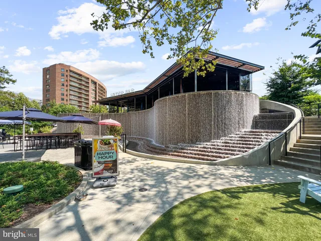 a store with couple of cars parked in front of building