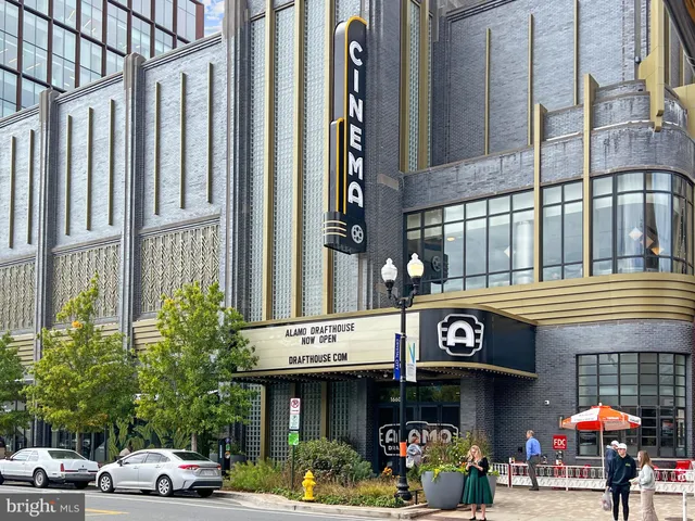 a view of a house with a yard and potted plants