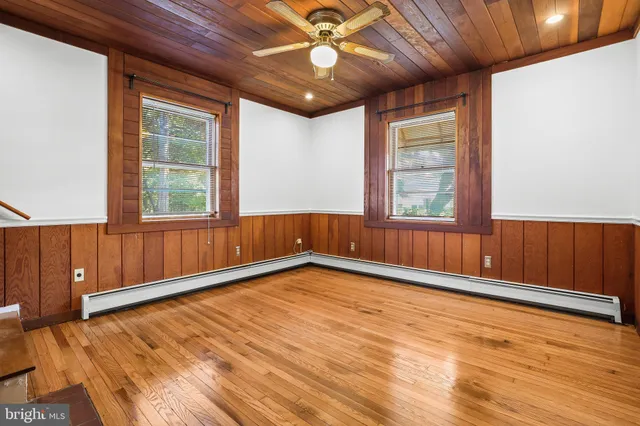 a view of a livingroom with wooden floor and a fireplace