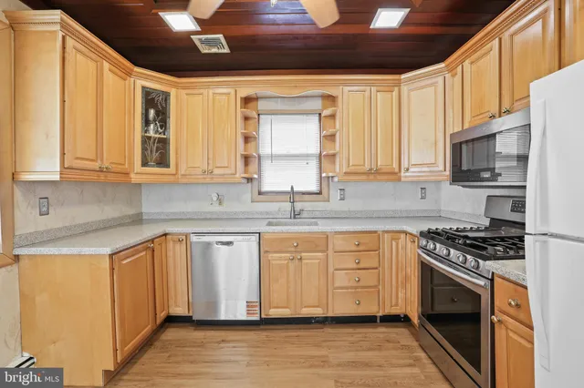 a hallway with wooden floor and windows