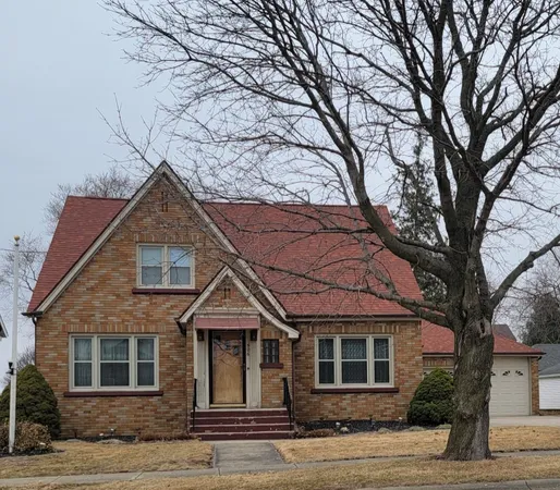 a front view of a house with a trees