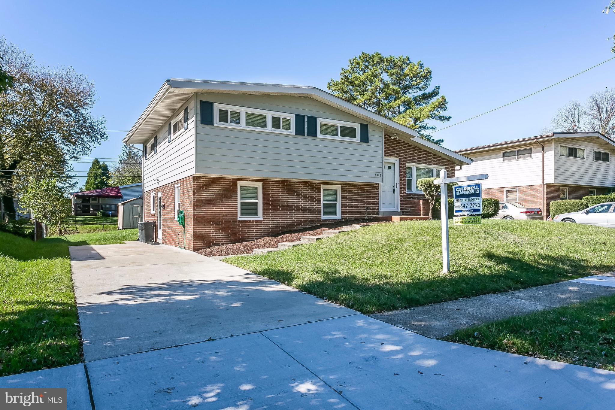 7313 Campfield Road Baltimore, MD 21208 - Photo 2 of 19 a front view of a house with a garden and yard