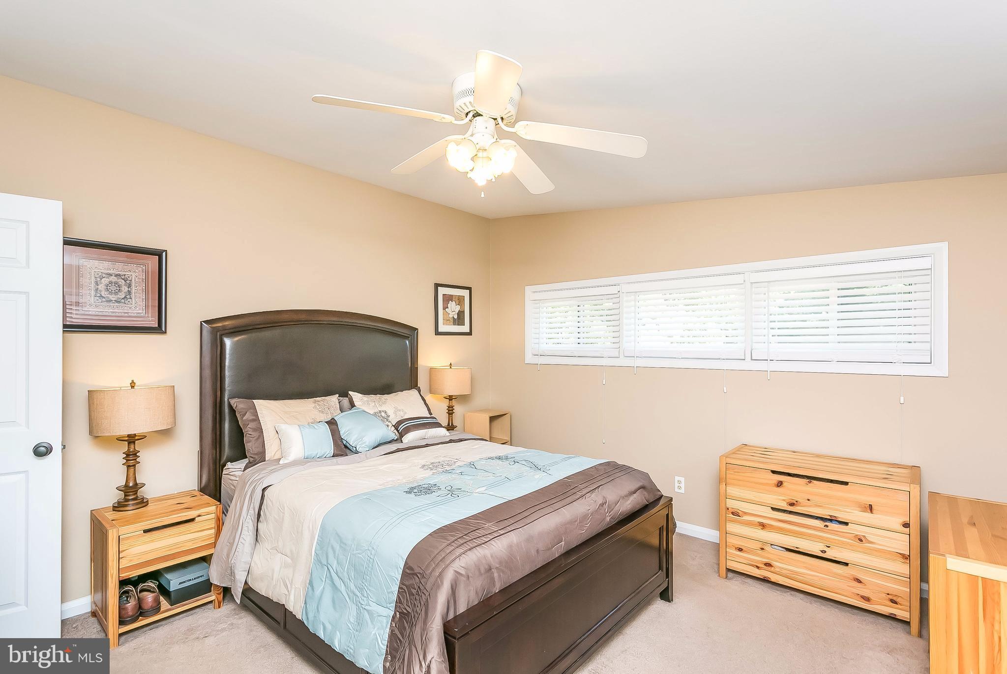 7313 Campfield Road Baltimore, MD 21208 - Photo 12 of 19 a bedroom with a bed and a chandelier