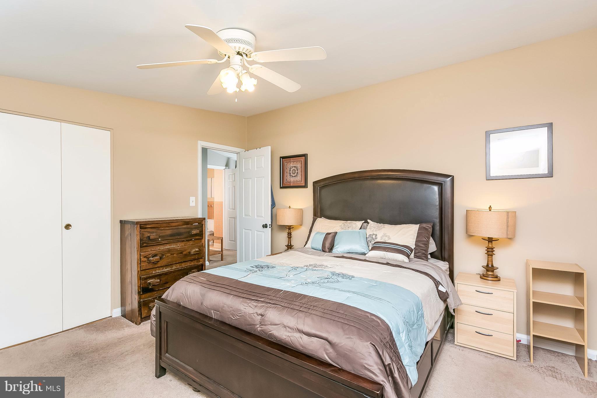 7313 Campfield Road Baltimore, MD 21208 - Photo 13 of 19 a bedroom with a bed and wooden floor