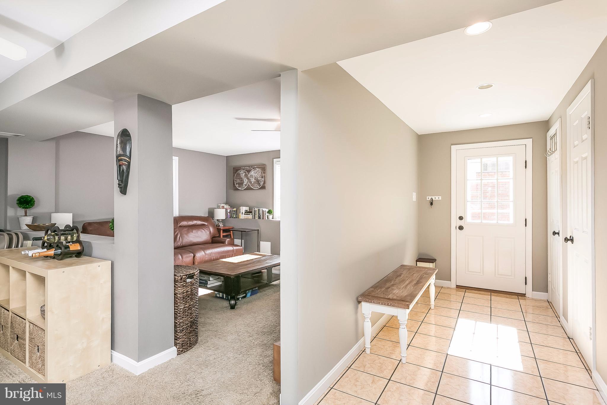 7313 Campfield Road Baltimore, MD 21208 - Photo 8 of 19 a view of a hallway with workspace and a livingroom