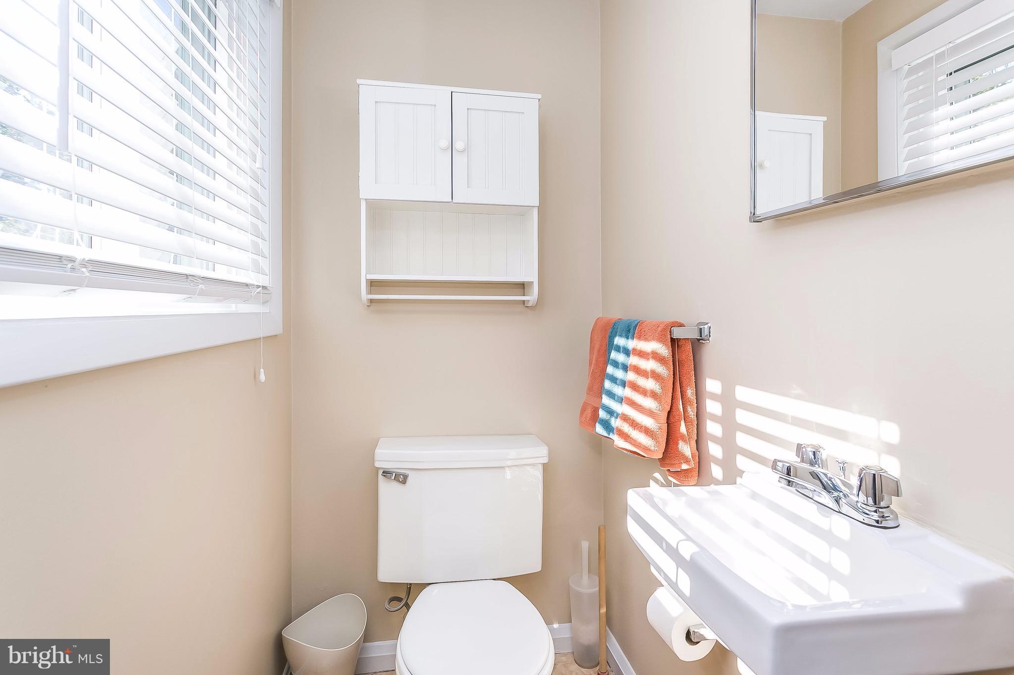 7313 Campfield Road Baltimore, MD 21208 - Photo 9 of 19 a white toilet sitting next to a bathroom sink