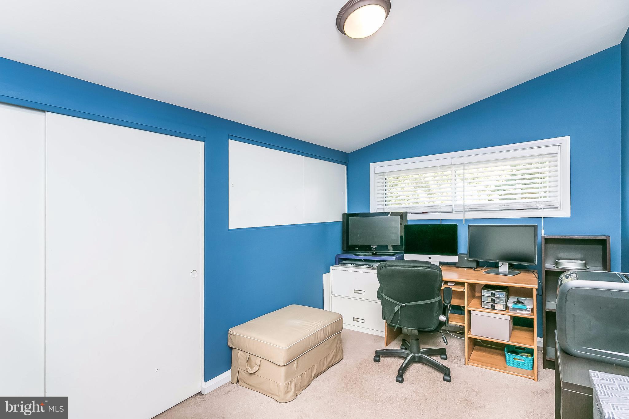 7313 Campfield Road Baltimore, MD 21208 - Photo 10 of 19 a view of a workspace with furniture and a window