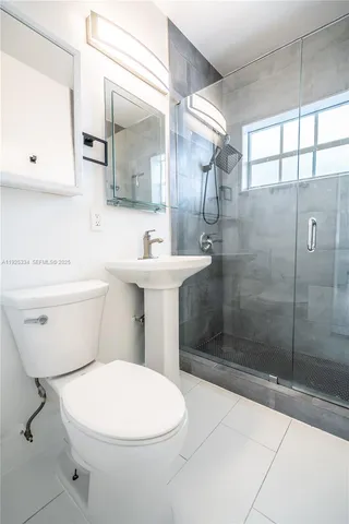 a bathroom with a toilet sink and shower
