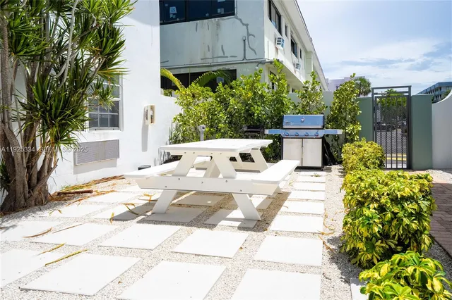 a view of a patio with table and chairs and potted plants