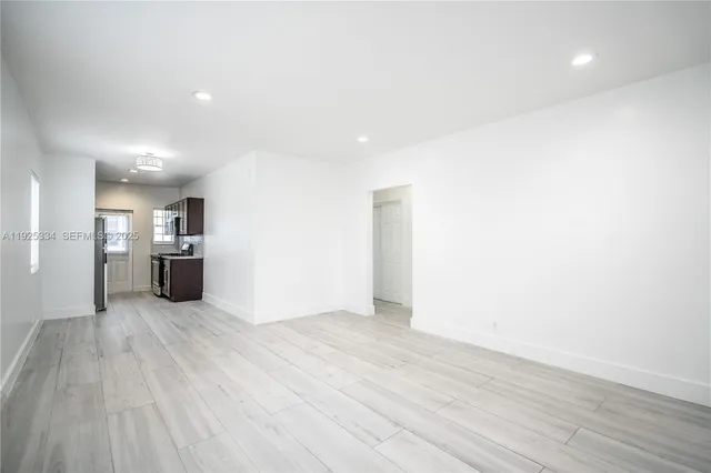 a view of a kitchen with a sink and a refrigerator