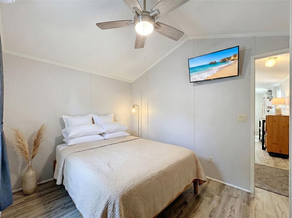 2092 Culbreath Road, Unit A42 Brooksville, FL 34602 - Photo 60 of 70 a bedroom with a bed and a chandelier