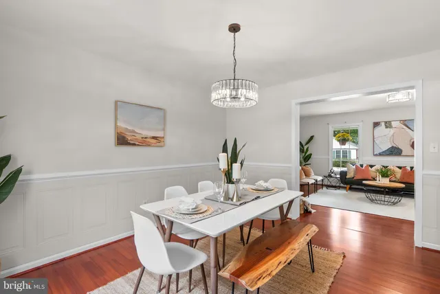 a view of a dining room with furniture wooden floor and chandelier