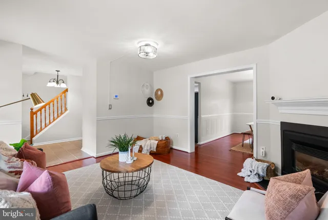 a living room with furniture potted plant and a fireplace
