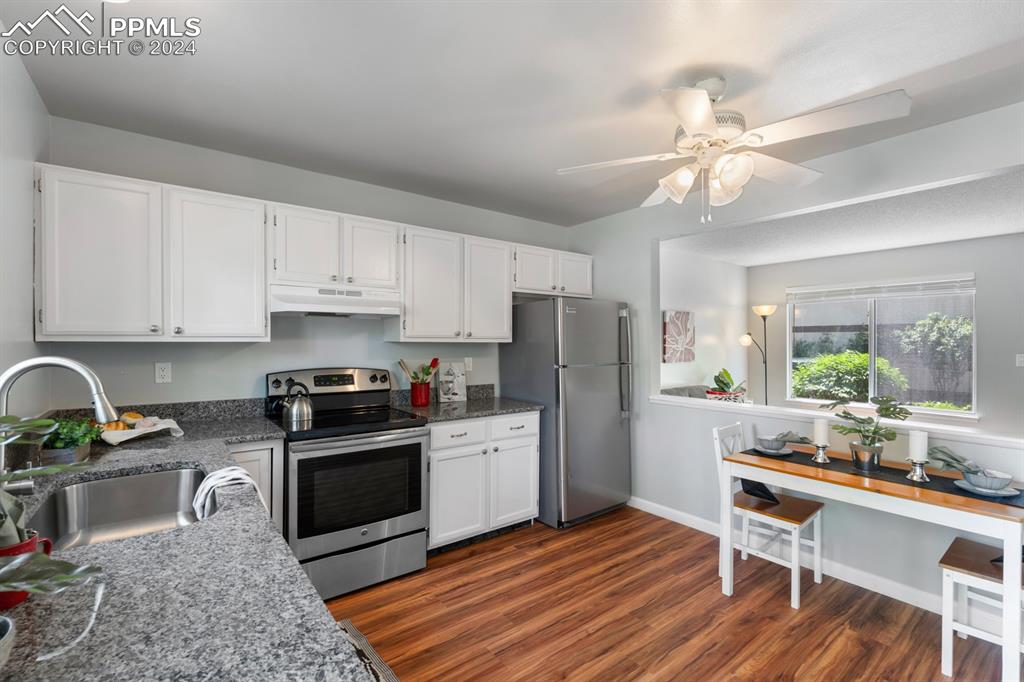 757 Alexander Road, Unit C Colorado Springs, CO 80909 - Photo 11 of 29 Kitchen with appliances with stainless steel finishes, sink, dark hardwood / wood-style floors, and ceiling fan