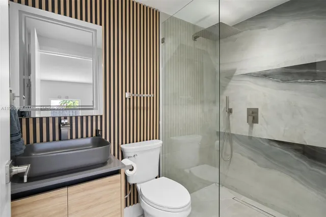 a bathroom with a toilet and a shower