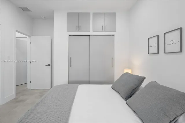 a bedroom with a bed and a closet