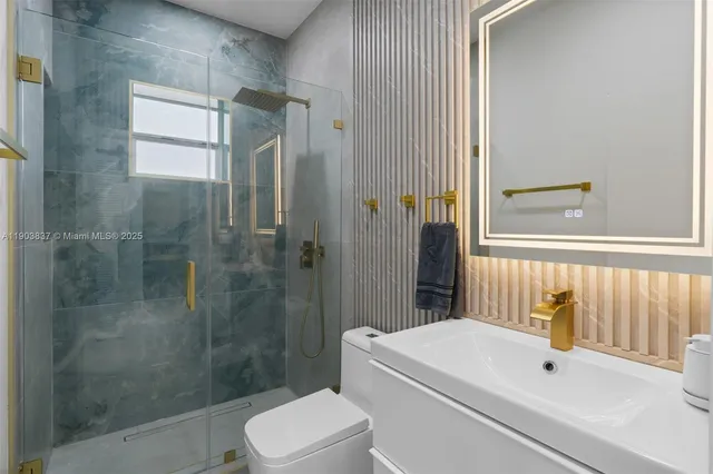 a bathroom with a white toilet sitting next to a bathroom sink