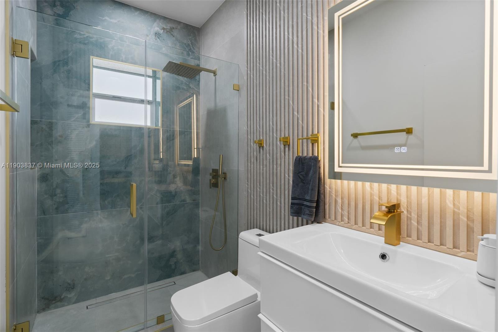 4301 Northwest 4th Street, Unit B Miami, FL 33126 - Photo 31 of 46 a bathroom with a white toilet sitting next to a bathroom sink