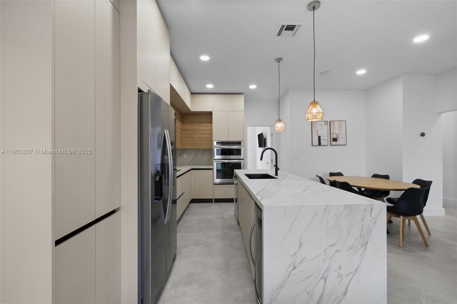 4301 Northwest 4th Street, Unit B Miami, FL 33126 - Photo 34 of 46 a kitchen with kitchen island a counter top space a sink stainless steel appliances and cabinets
