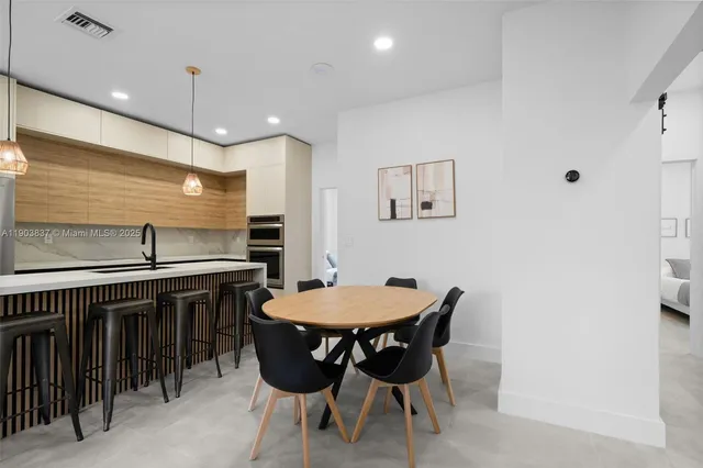 a kitchen with a table and chairs in it
