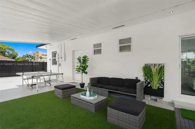 a living room with furniture potted plant and a window